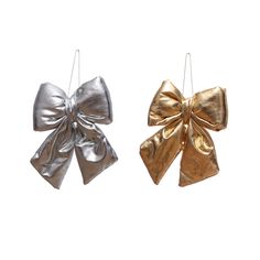 two gold and silver bows hanging from strings