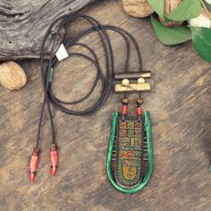 Handmade Artistic Wooden Symbol Necklace 🖌️🎨🌿 📋 Materials: Leather, Wood, Ceramic 📏 Length: Adjustable 19.6 inches/50cm  Pendant Widht: 1.9inches / 5cm Pendant Lenght: 3.9inches / 10cm  🌟 Unique: This necklace is one-of-a-kind, meaning the owner will possess the only piece in existence. Discover the beauty of handmade jewelry with our artisan pendant necklace. Featuring a unique ceramic pendant, this boho necklace showcases exquisite craftsmanship. Perfect as a birthday gift or a special g Bohemian Hand Tooled Green Jewelry, Unique Green Fair Trade Necklace, Artisan Hand Painted Adjustable Necklace, Green Amulet Necklace For Festival, Artisan Hand-tooled Necklace For Gift, Traditional Hand Painted Adjustable Necklace, Traditional Adjustable Hand Painted Necklace, Traditional Adjustable Cord Festival Jewelry, Unique Hand Painted Necklaces For Festivals