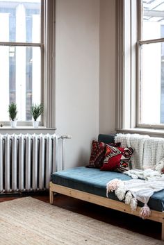 a living room with a couch, rug and radiator