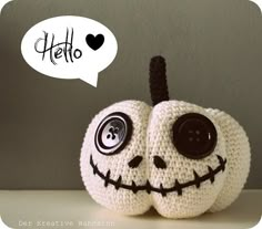 a crocheted jack - o - lantern with a speech bubble above it