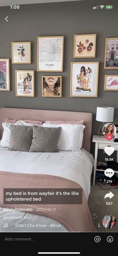 a bed room with a neatly made bed and many pictures on the wall above it