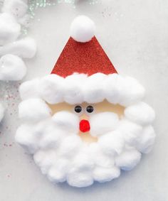 a santa clause ornament made out of white foam and red glitter on it