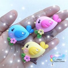 three little birds sitting on top of each other in the palm of someone's hand