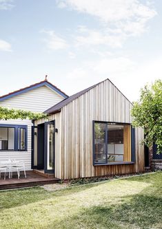 a small wooden house sitting on top of a lush green field