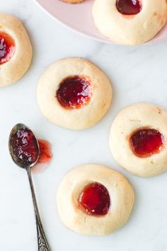 small cookies with jam on them and a spoon