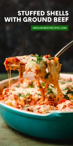 a blue casserole dish filled with stuffed shells and cheese