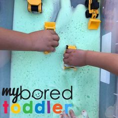 two children are playing with toys in a play area that says, my bored todder