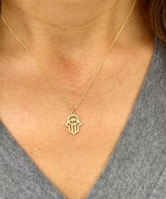 Embrace elegance and meaningful symbolism with this Hamsa style pendant and chain, crafted in 14k solid yellow gold.  This minimalist necklace features a beautifully designed Hamsa charm, symbolizing protection, luck, and good fortune. Perfect for weddings, bridal gifts, or anniversaries, this necklace combines timeless beauty with heartfelt sentiment.  The delicate and dainty design ensures it complements any outfit, adding a touch of sophistication and grace. Presented in an elegant gift box, Spiritual 14k Gold-filled Yellow Gold Charm Necklace, Spiritual 14k Gold Filled Yellow Gold Charm Necklaces, Dainty Yellow Gold Brass Charm Necklace, 14k White Gold Charm Necklace With Adjustable Chain, Spiritual 14k Gold Charm Necklace With Round Pendant, 14k Gold Spiritual Round Pendant Charm Necklace, 14k Yellow Gold Tarnish Resistant Charm Necklace, Wedding Pendant Charm Necklaces, Tarnish Resistant, Delicate Yellow Gold Brass Charm Necklaces