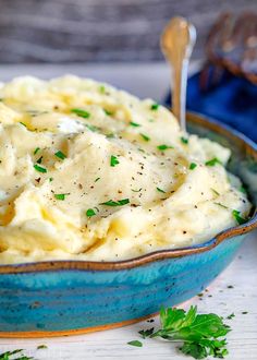 mashed potatoes with parsley in a blue bowl