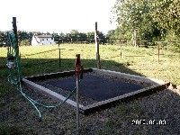 there is an empty trampoline in the yard