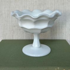 a white bowl sitting on top of a green table