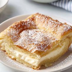 a white plate topped with pastry on top of a table