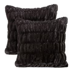 two black fur pillows sitting on top of each other