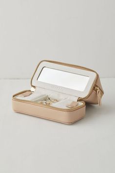 an open jewelry box with two rings inside on a white surface, one opened and the other closed