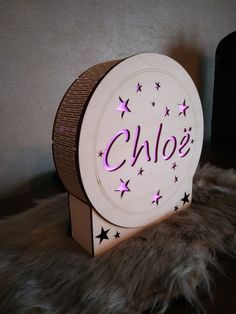 a wooden sign with stars on it that says chloe's in purple letters and the word charlotte