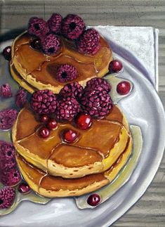 pancakes with raspberries and syrup on a plate