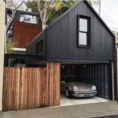 a car is parked in front of a garage