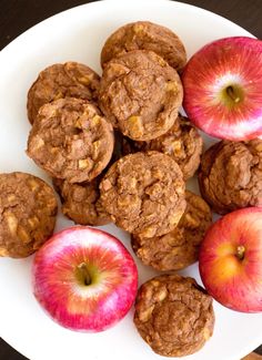 some apples and cookies on a white plate