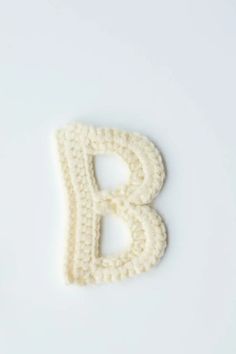 the letter b is knitted in white yarn