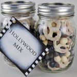 two glass jars filled with different types of beads and other things in them that are labeled hollywood mix