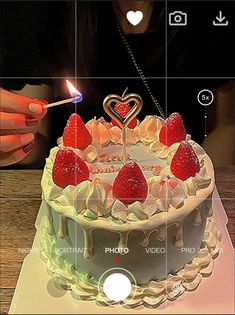 the cake is decorated with strawberries and candles