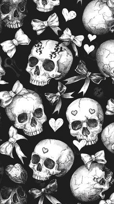 black and white skulls with bows and hearts on them, all in the same pattern