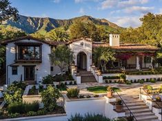 the exterior of a home with landscaping and mountains in the backgroung area