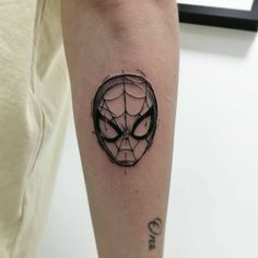 a spider - man tattoo on the left forearm and right arm is shown in black ink