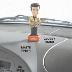 a bobble head figure sitting on top of a car dashboard with the words gloss finish and glossy finish