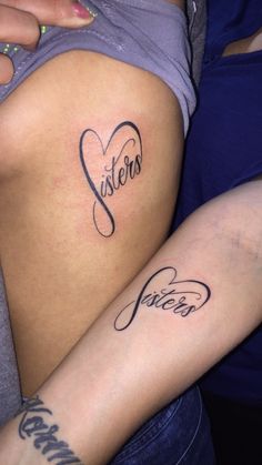 two women with tattoos on their stomachs, one has the word sister written in cursive writing