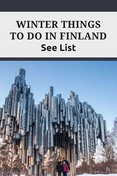 two people standing in front of a tall metal structure with the words winter things to do in finland see list