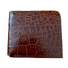 The Croc Embossed Bifold Wallet This veg-tanned, authentic Croc Embossed Men's wallet is as durable as it is timeless. This gorgeous leather wallet features a timeless bi-fold design that will keep your belongings organized. As with all of our wallets, customization options are available, just email us at info@leatherpasture.com with any modifications you may want to any of our bags Our products are handmade to order, just for you! Production time is approx. 10-15 business days. We ship with USPS Priority Mail / UPS, which typically has a 2-3 day delivery time within the US, or 6-10 days internationally. Specs: • USA-made in our North Carolina workshop • Croc Embossed veg-tanned leather • 2-pocket design for cards and cash • Interior flip-out pocket for cash/ receipts Measurements: 3 3/4” Brown Bifold Coin Purse For Business, Rectangular Wallets With Leather Lining For Everyday Carry, Leather Bifold Coin Purse With Rfid Blocking, Classic Brown Bifold Coin Purse, Brown Embossed Wallet, Brown Embossed Leather Wallet, Brown Embossed Wallet For Daily Use, Brown Embossed Wallets For Daily Use, Classic Leather Bifold Coin Purse