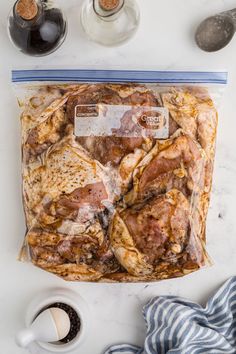 a bag of food sitting on top of a counter next to some cups and spoons