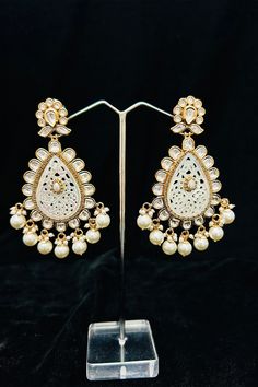 Description: Enhance your elegance and make a statement with our Gold Plated Dazzling Royal Kundan Beaded Earrings. The intricate design and sparkling kundan beads add a touch of royalty to your outfit. Perfect for any occasion, these earrings will surely impress. About: Best for gifting or for personal use, wear it to any occasion and be the spotlight. Eye-catching and unique jewelry that will set you apart. Gift this piece to a loved one and see their face light up with joy. Temple Jewelry Beaded Earrings For Parties, Traditional Jeweled Pearl Earrings For Party, Traditional White Pearl Earrings For Reception, Elegant White Danglers With Stone Work, White Danglers With Intricate Design For Reception, Festive Jeweled Chandbali Pearl Earrings, Elegant Kundan Danglers For Celebration, Elegant Jeweled Jhumkas For Diwali, Elegant Kundan Bridal Earrings For Festive Occasions