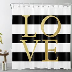 a black and white shower curtain with the word love in gold on it's side