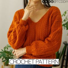 a woman in an orange sweater is holding her hand on her chin and looking at the camera