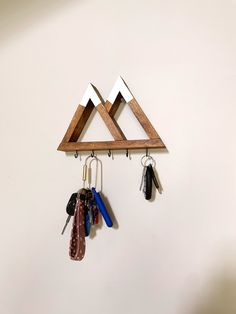 a pair of mountains hanging on a wall with key hooks and keys attached to them