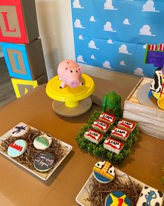 a table topped with cakes and cupcakes covered in fondant