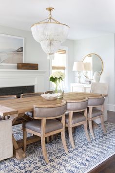 a dining room table with chairs and a chandelier