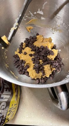 a metal bowl filled with chocolate chips and peanut butter