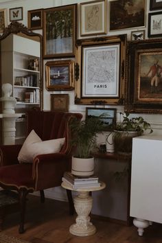 a living room filled with lots of framed pictures