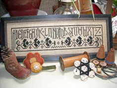 a cross - stitch sample is displayed on a table