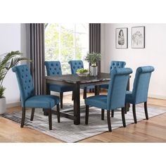 a dining room table with blue chairs around it