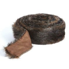 a brown and black fur hat on top of a white surface