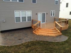 a wooden deck with steps leading up to a house