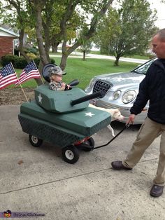 a man pulling a wagon with a child in it and an american flag on top