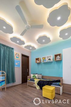 a child's bedroom with blue walls and clouds painted on the ceiling above it