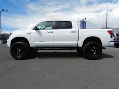 a white truck parked in a parking lot