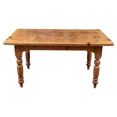 an old wooden table with turned legs on a white background