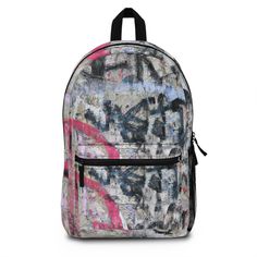 a backpack with graffiti on the front and side panels, black straps, and zipper closures